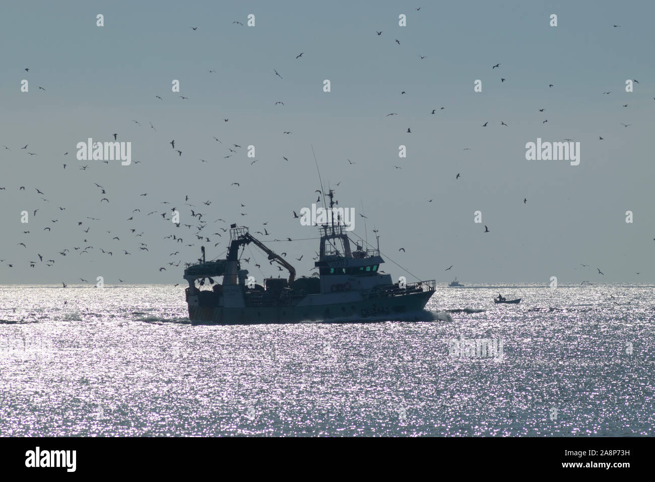 A trawler puts out to sea from Peniche Portugal - which is one of the largest fishing ports for sardines Stock Photo