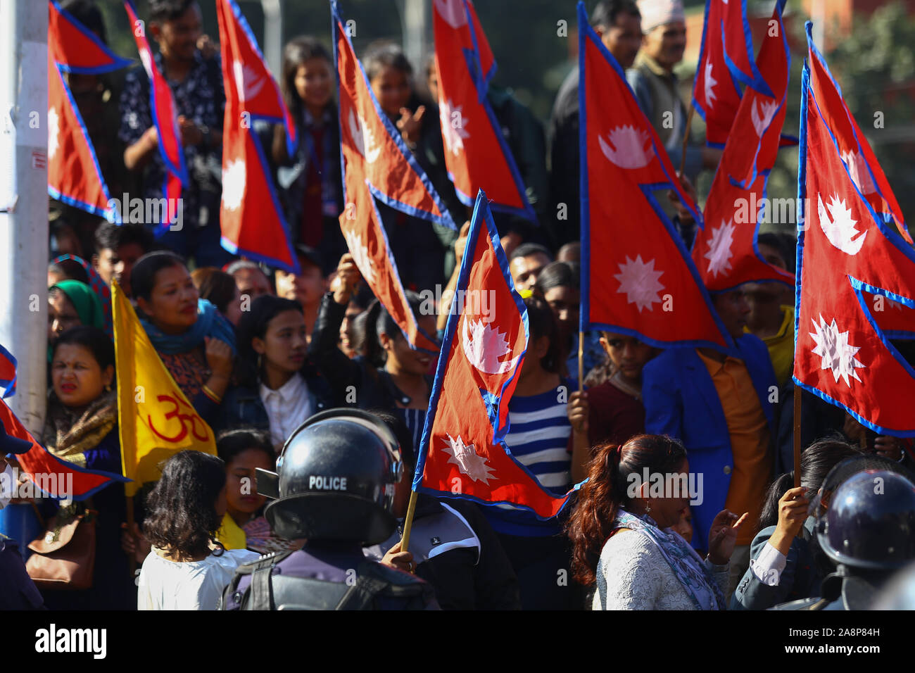 Nepalese wave flags during an anti-India protest.Hundreds of Nepalese including students, gathered to protest against new India political map released which includes the Nepals land Kalapani and Lipulek as part of the Indian Territory. Stock Photo