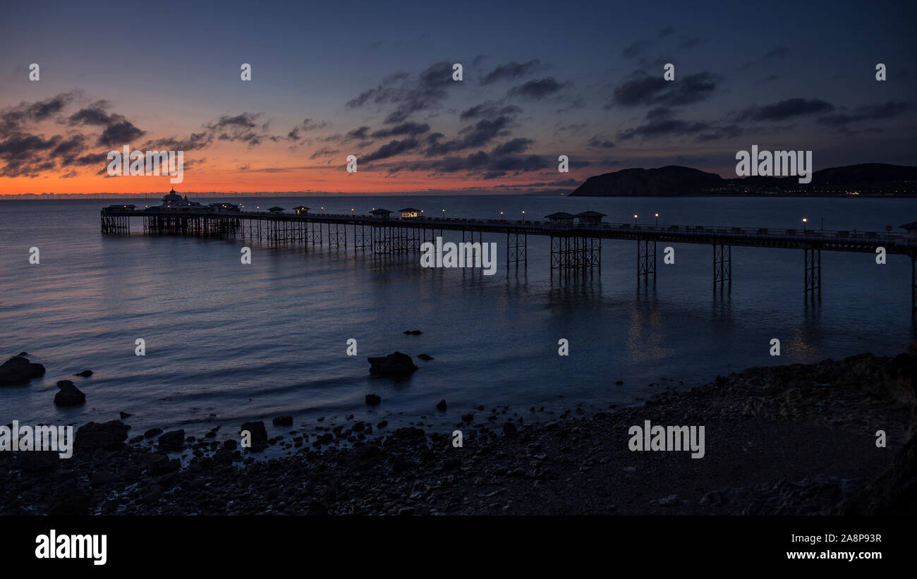 Dawn over the Victorian pier at Llandudno on the North Wales coast Stock Photo