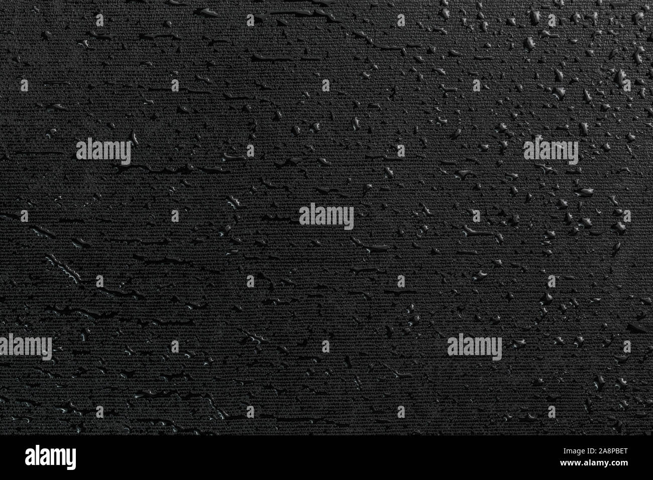 water drops on black flat rubber surface dark macro background Stock Photo