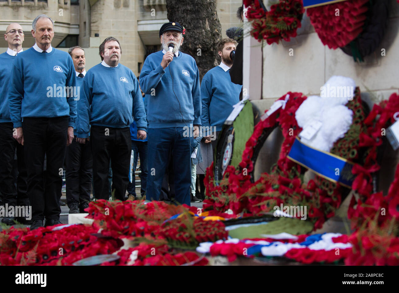 London, UK. 10 November, 2019. Jim Radford (c), D-Day veteran and folk singer, sings ‘1916’ in front of ex-services personnel from Veterans For Peace UK (VFP UK) taking part in the Remembrance Sunday ceremony at the Cenotaph. VFP UK was founded in 2011 and works to influence the foreign and defence policy of the UK for the larger purpose of world peace. Credit: Mark Kerrison/Alamy Live News Stock Photo