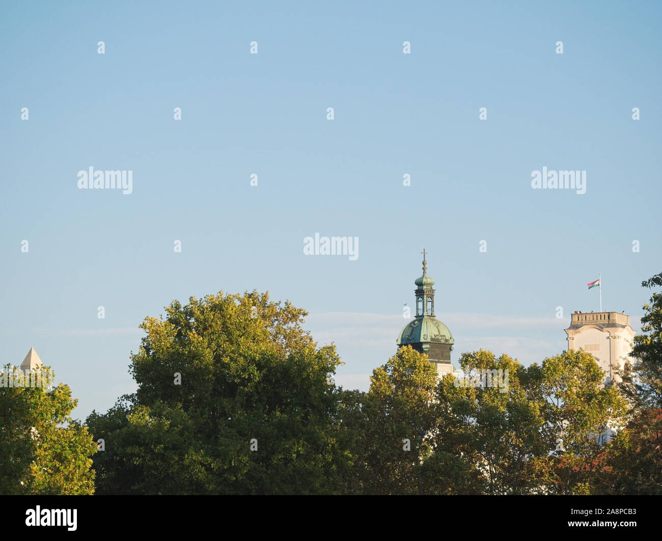 Landmarks of Győr City Rising above Treetops on a Sunny Autumn Day Stock Photo