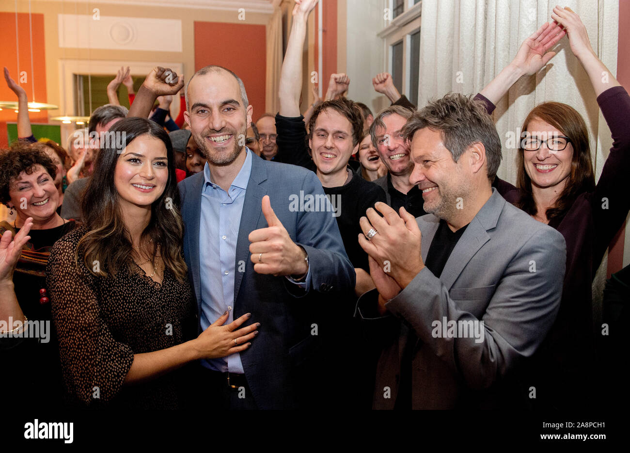 Hanover, Germany. 10th Nov, 2019. Belit Onay (M, Bündnis 90/Die Grünen), top candidate in the mayoral election, is pleased with his wife Derya (l), Robert Habeck, Federal Chairman of Bündnis 90/Die Grünen, and other supporters after the announcement of the election results. Since none of the ten candidates received more than 50 percent of the votes in the first ballot on 27 October 2019, a run-off ballot was held. Credit: Hauke-Christian Dittrich/dpa/Alamy Live News Stock Photo