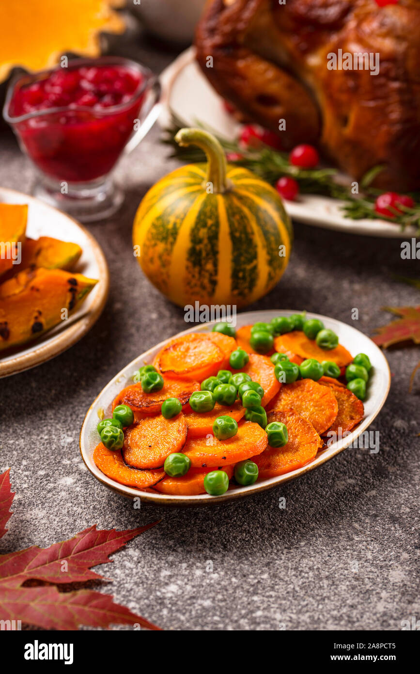 Glazed roasted carrot with peas Stock Photo Alamy