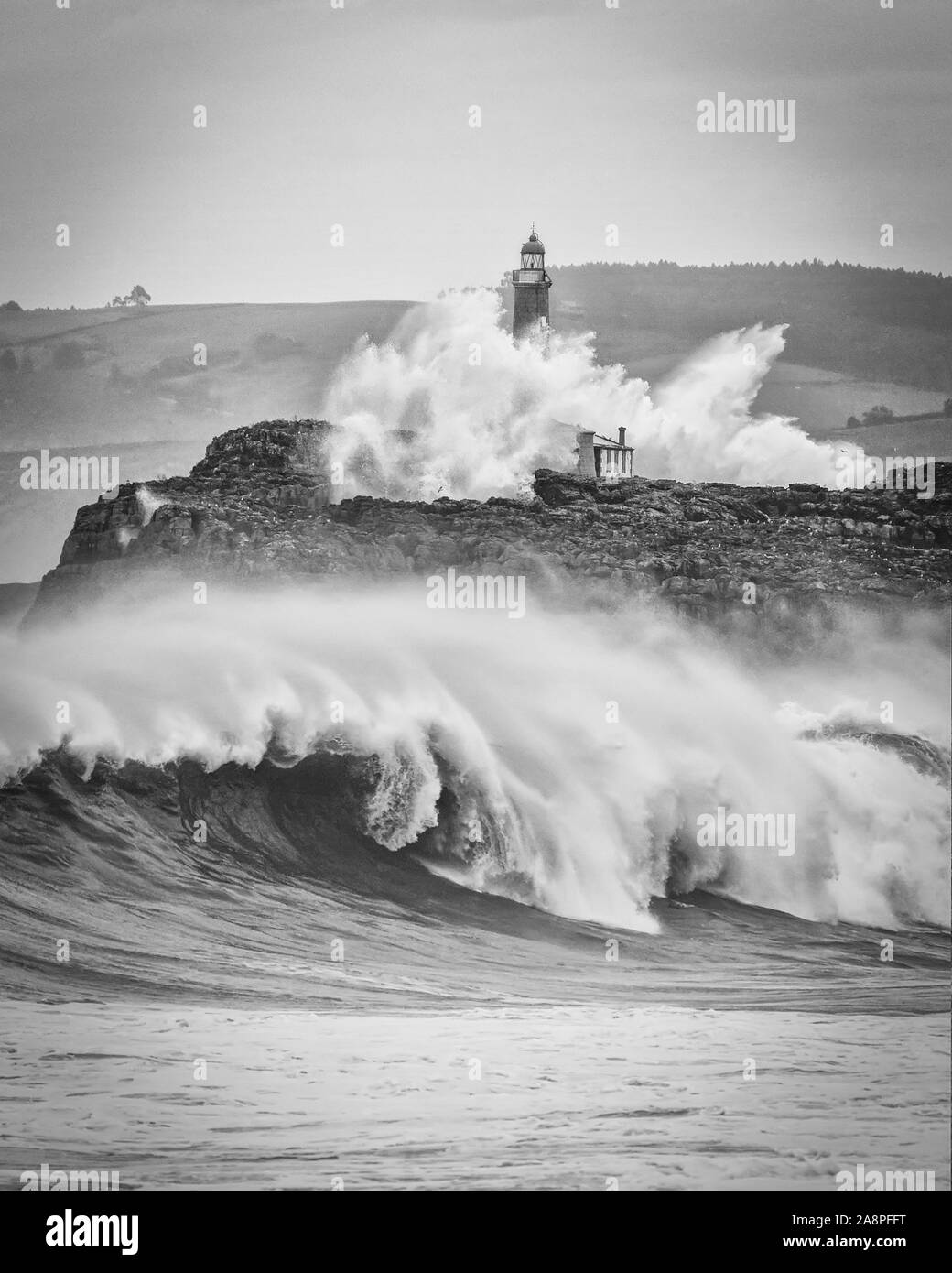 Huge waves splashing at the Mouro island lighthouse Stock Photo