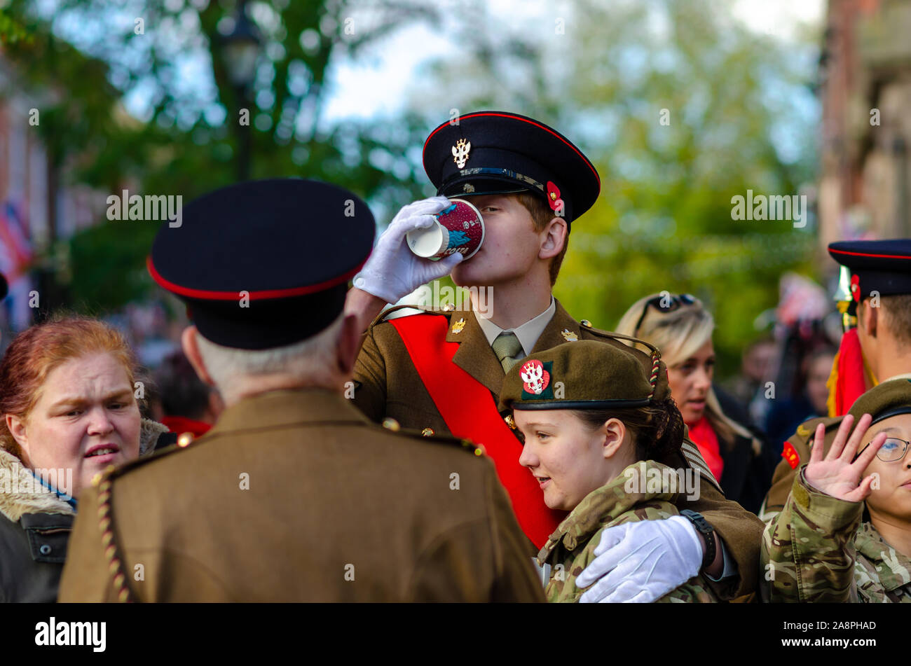 Photo of soldier drinking coffee and hugging    his friend after the Remembrance Day parade in Stone, Staffordshire, UK. Stock Photo