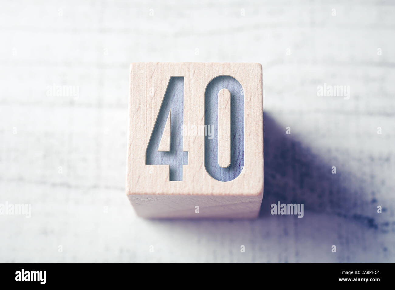 The Number 40 On A Wooden Block On A Table Stock Photo