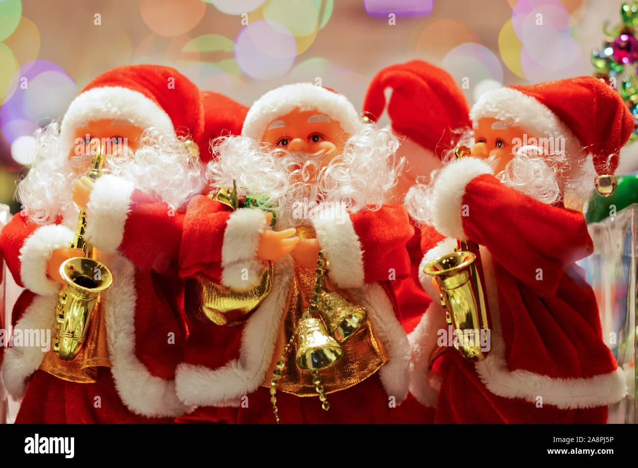 toys Santa Claus with golden saxophones, Christmas festive background Stock Photo