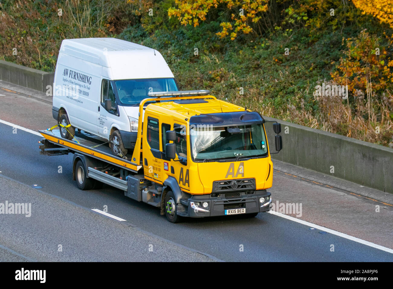 AA Roadside breakdown recovery;  Haulage delivery trucks, lorry, transportation, truck, cargo, vehicle, delivery, commercial transport, industry, on the M6 at Lancaster, UK Stock Photo