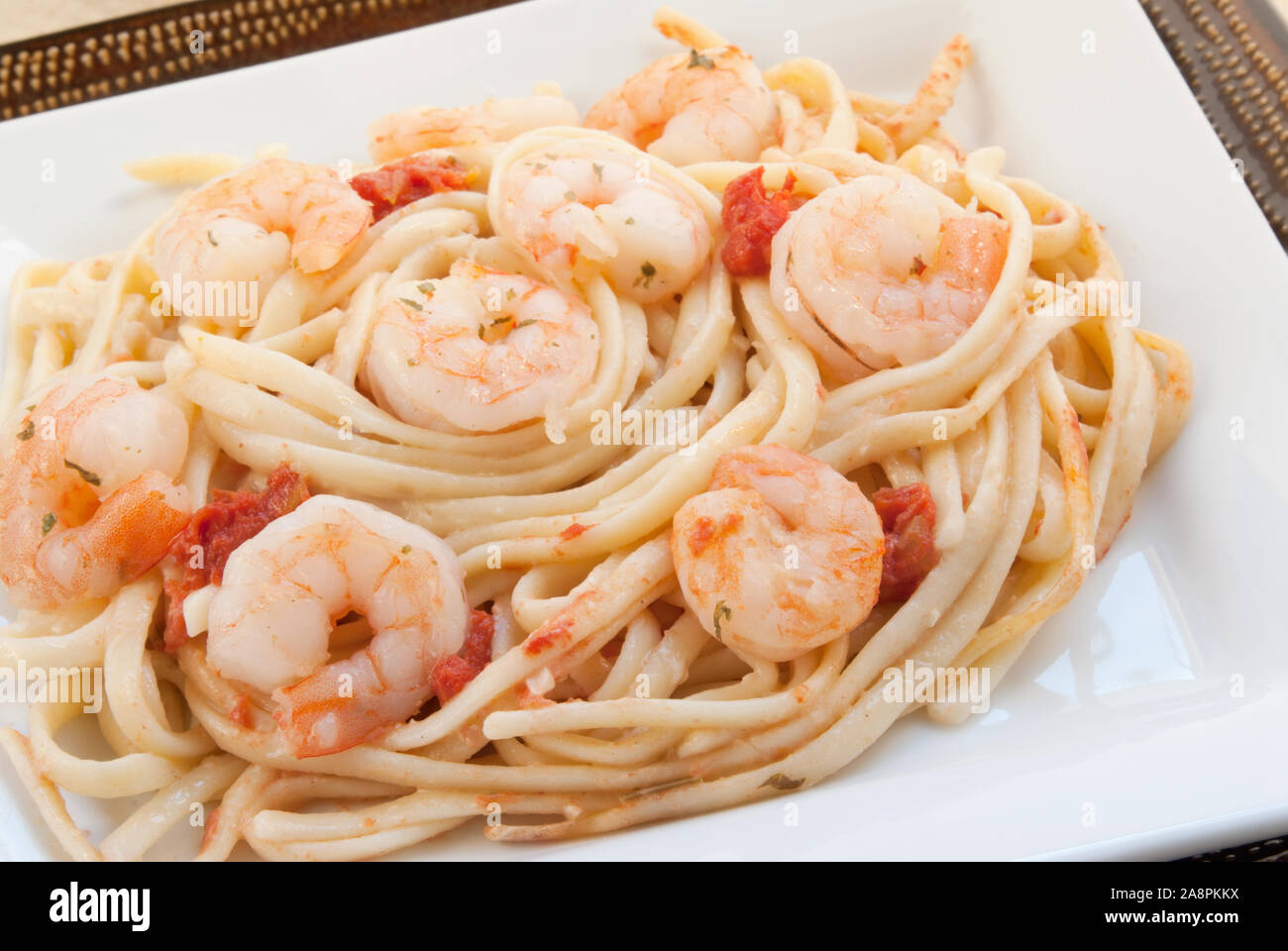 Homemade shrimp scampi served on a bed of linguini pasta noodles