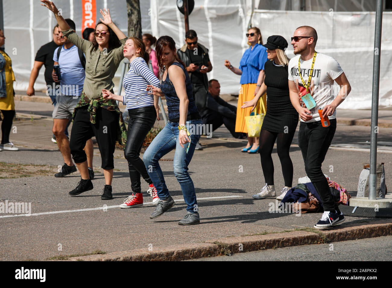 Young adults dancing in the street at Kallio Block Party 2019 in Helsinki, Finland Stock Photo