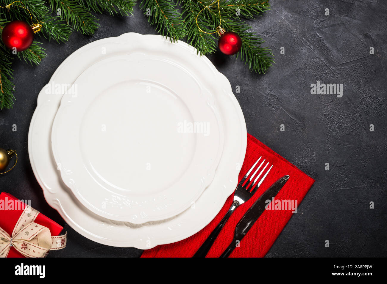 Christmas table setting on black Stock Photo - Alamy