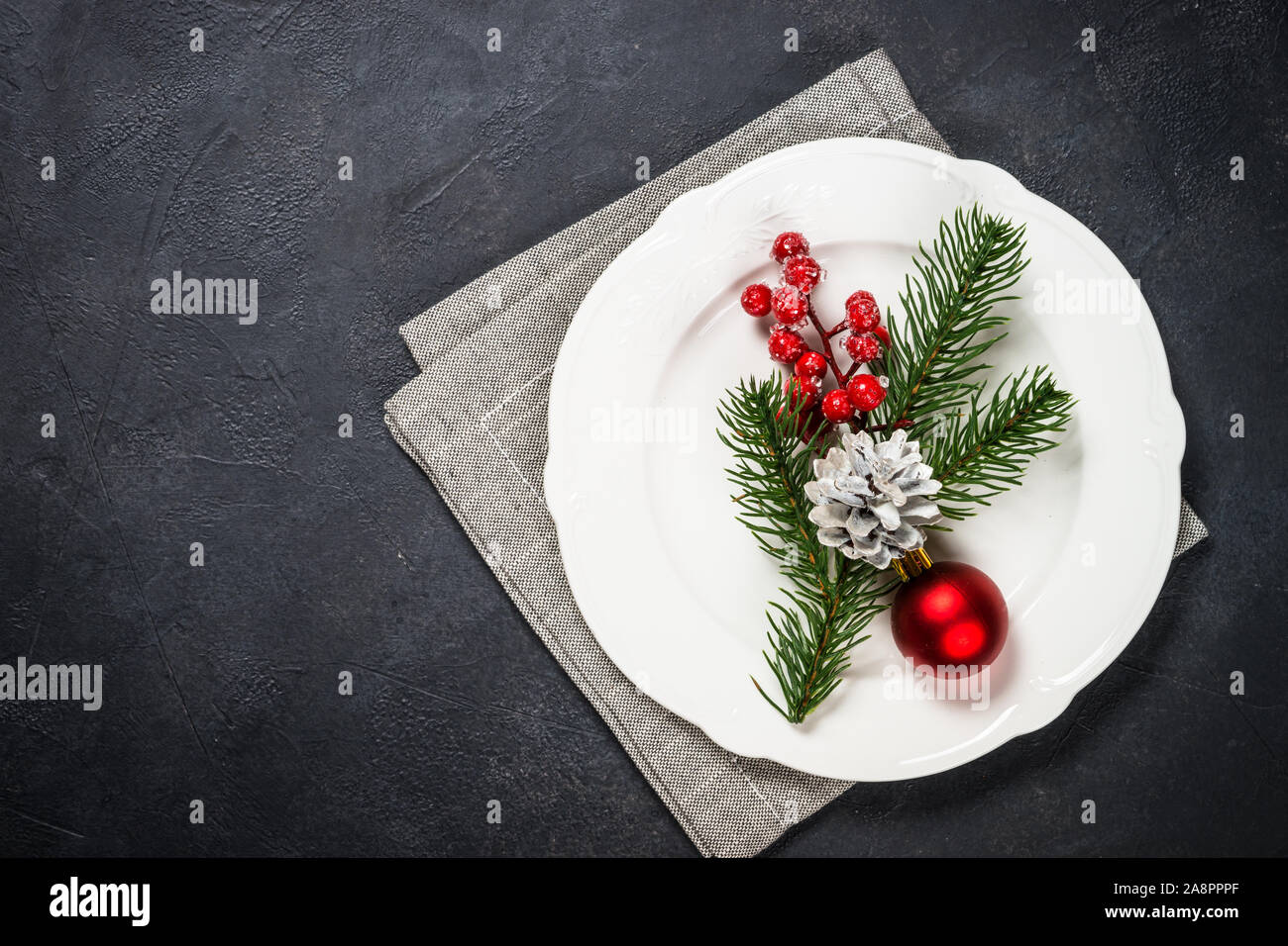 Christmas table setting on black Stock Photo - Alamy