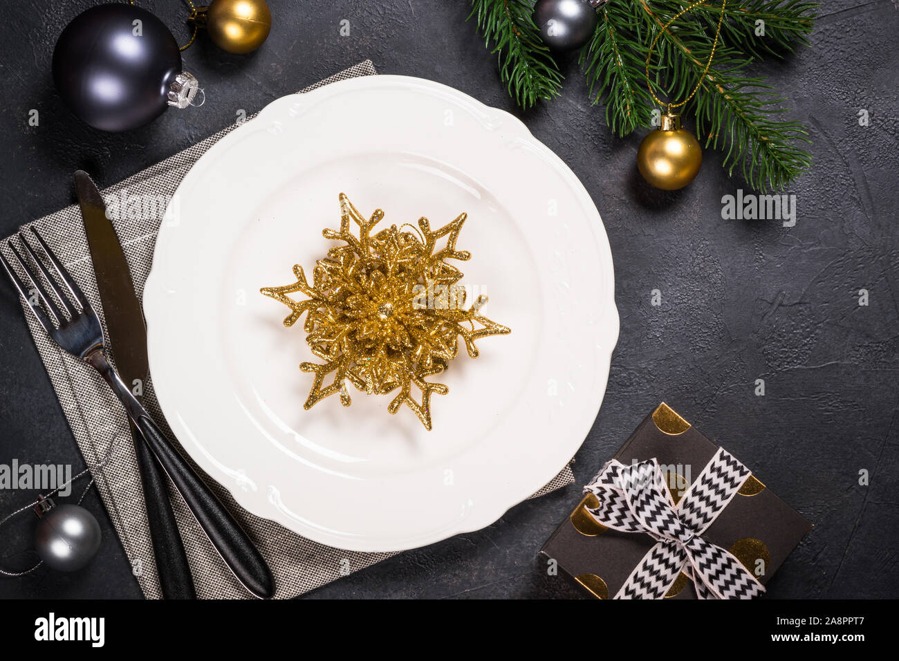 Christmas table setting on black Stock Photo - Alamy