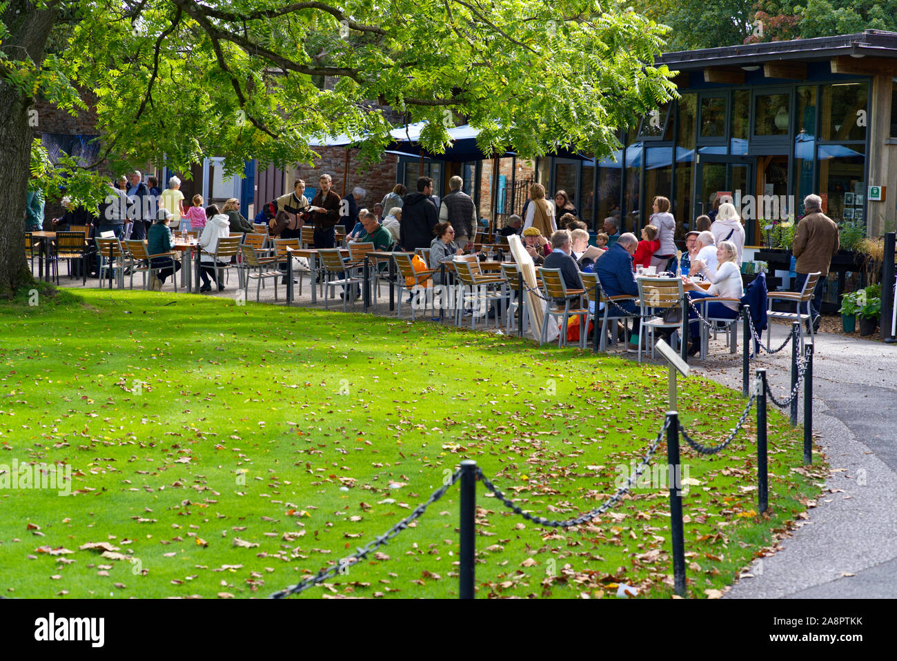 Visitors at the outdoor dining area at Bishop's Palace. Wells, Somerset, UK Stock Photo