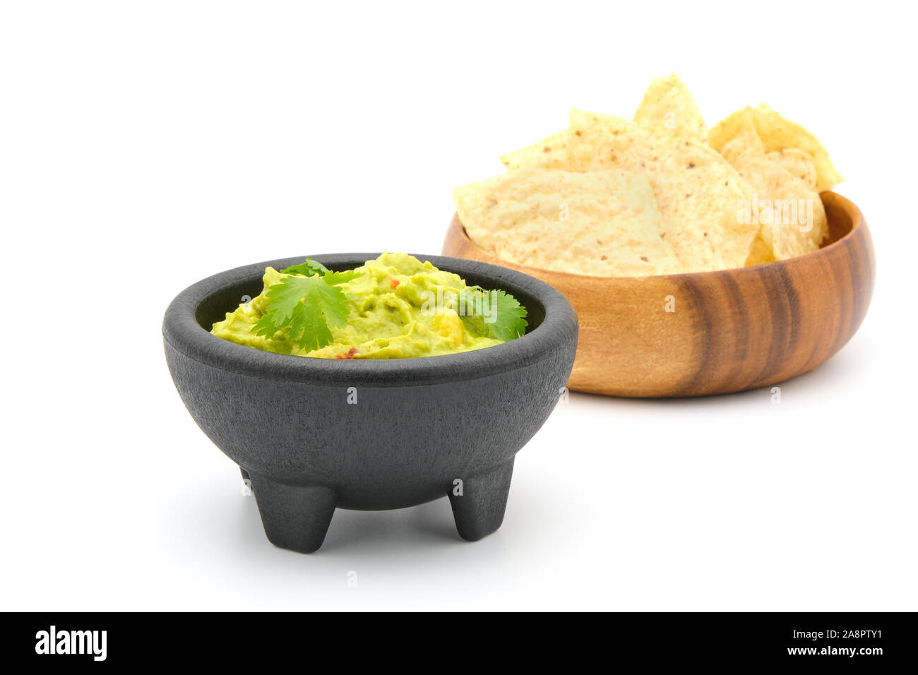 Bowl of fresh homemade guacamole with crispy tortilla chips. Stock Photo