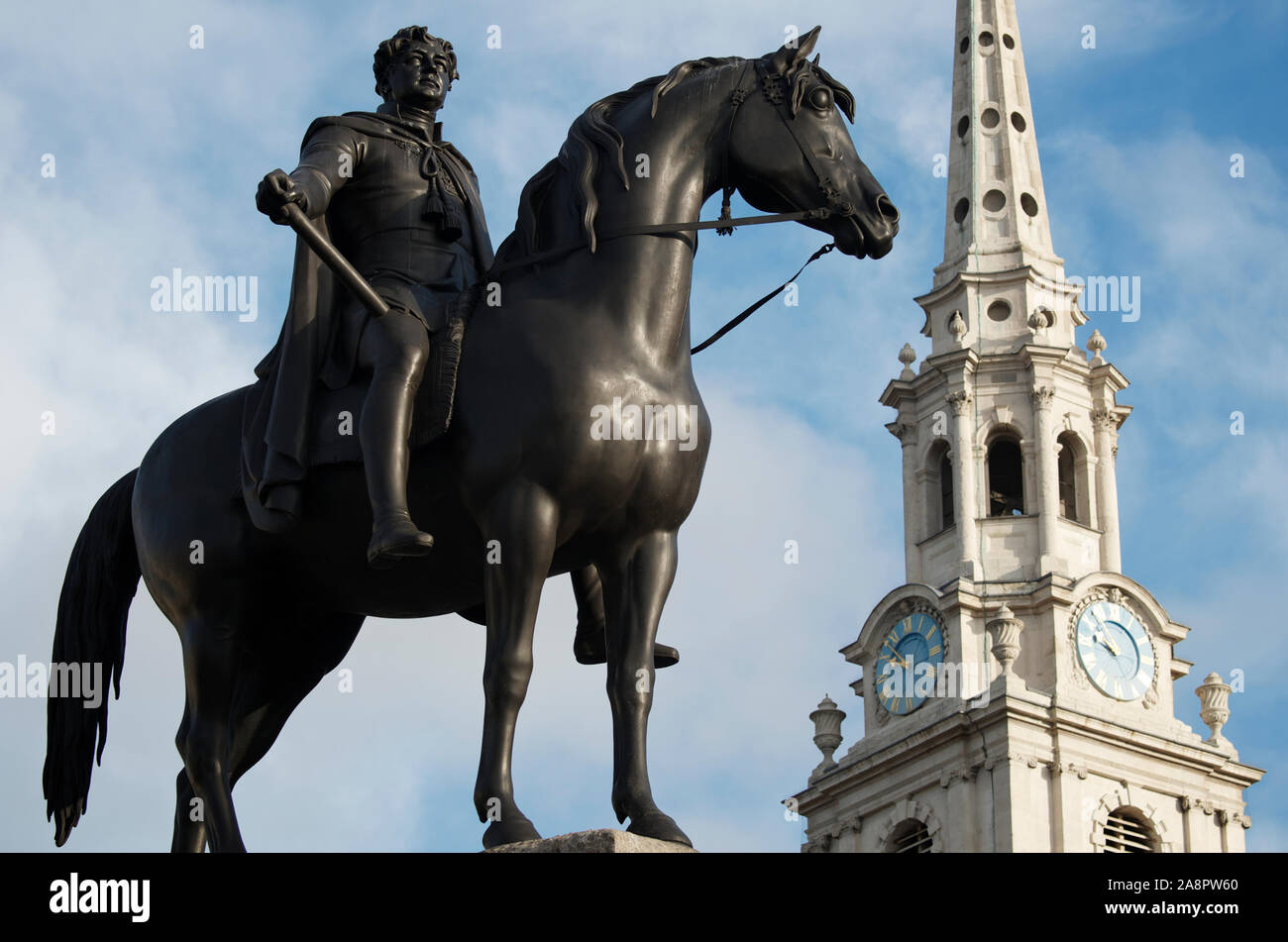 Equestrian statue of King George IV, cast in 1828, standing in front of the steeple of St Martin-in-the-Fields church in Trafalgar Square, London, UK Stock Photo