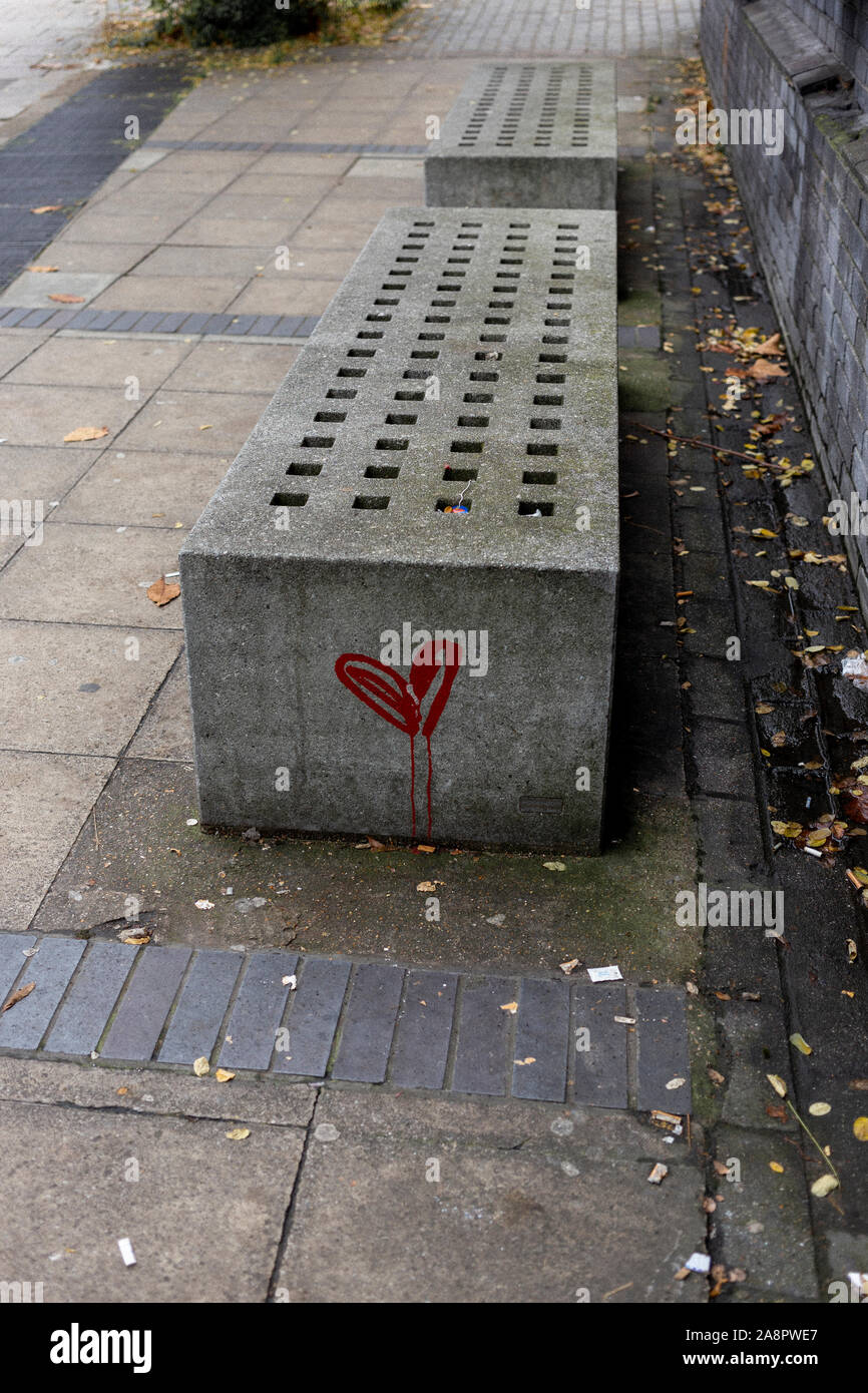 'Bleeding' heart graffiti on bench on pavement in Putney, London. Stock Photo