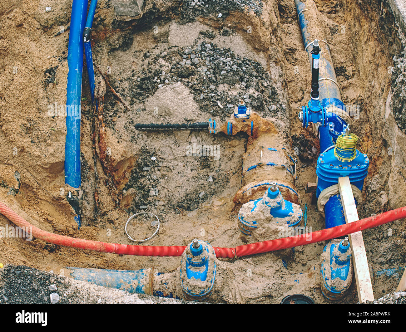 Plastic and steel pipes and valves underground. Repairing of main