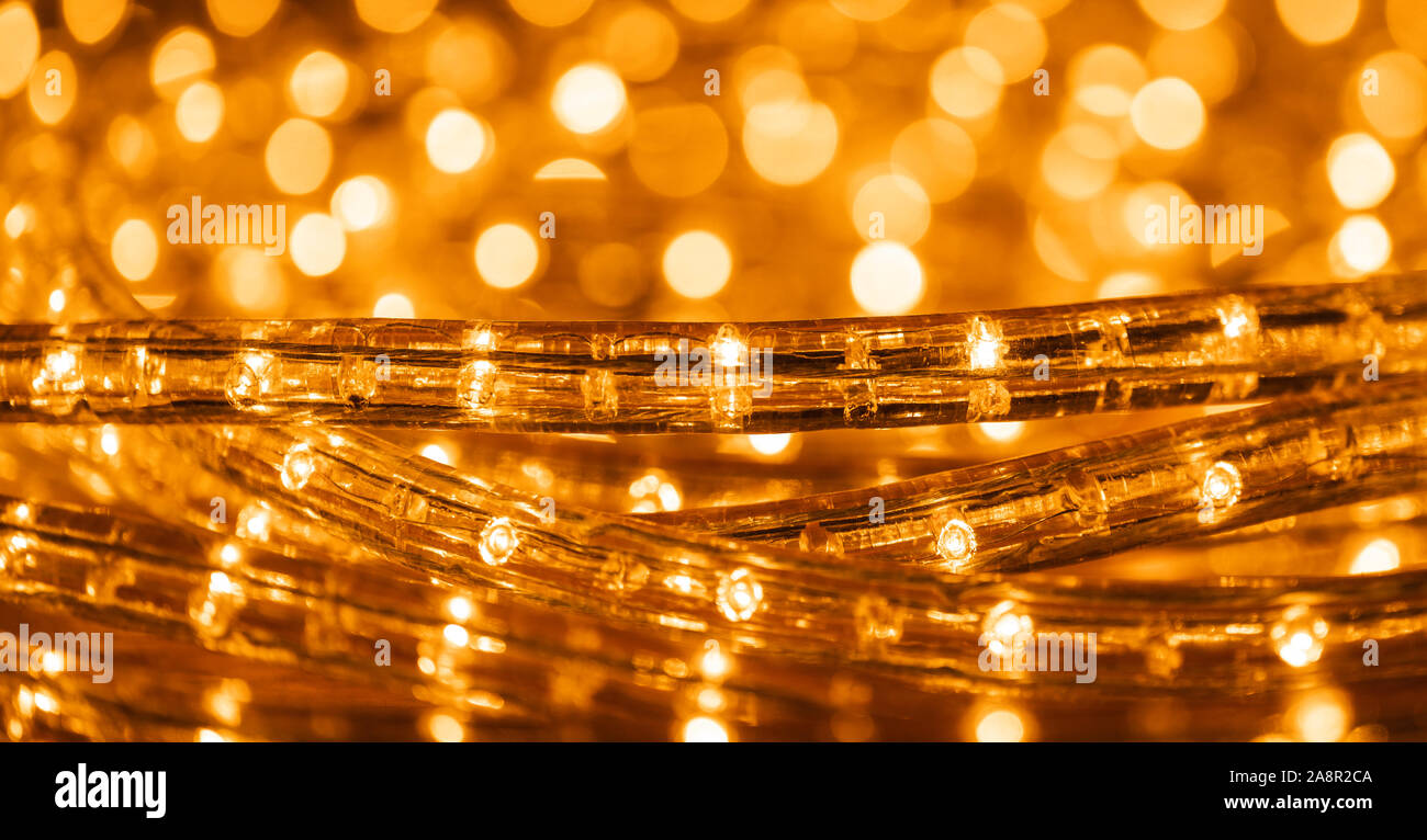 Christmas lights with low depht of focus. Blurry background. Abstract lights. Christmas or New Year. Golden colors. Stock Photo