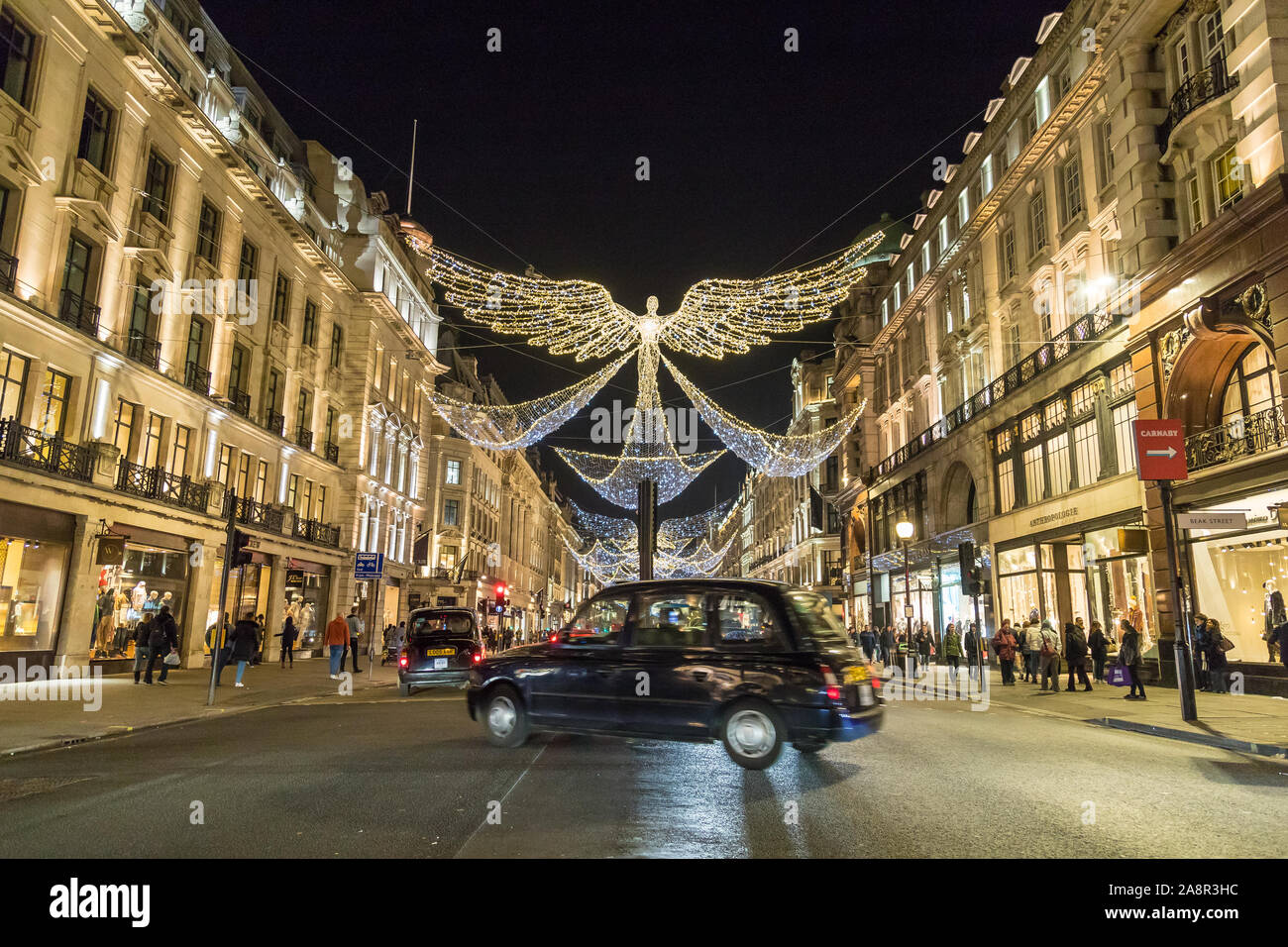 LONDON, UK - 17TH NOVEMBER 2018: Views along Regent Street at night showing Christmas decorations along the street. A typical London Black Cab can be Stock Photo