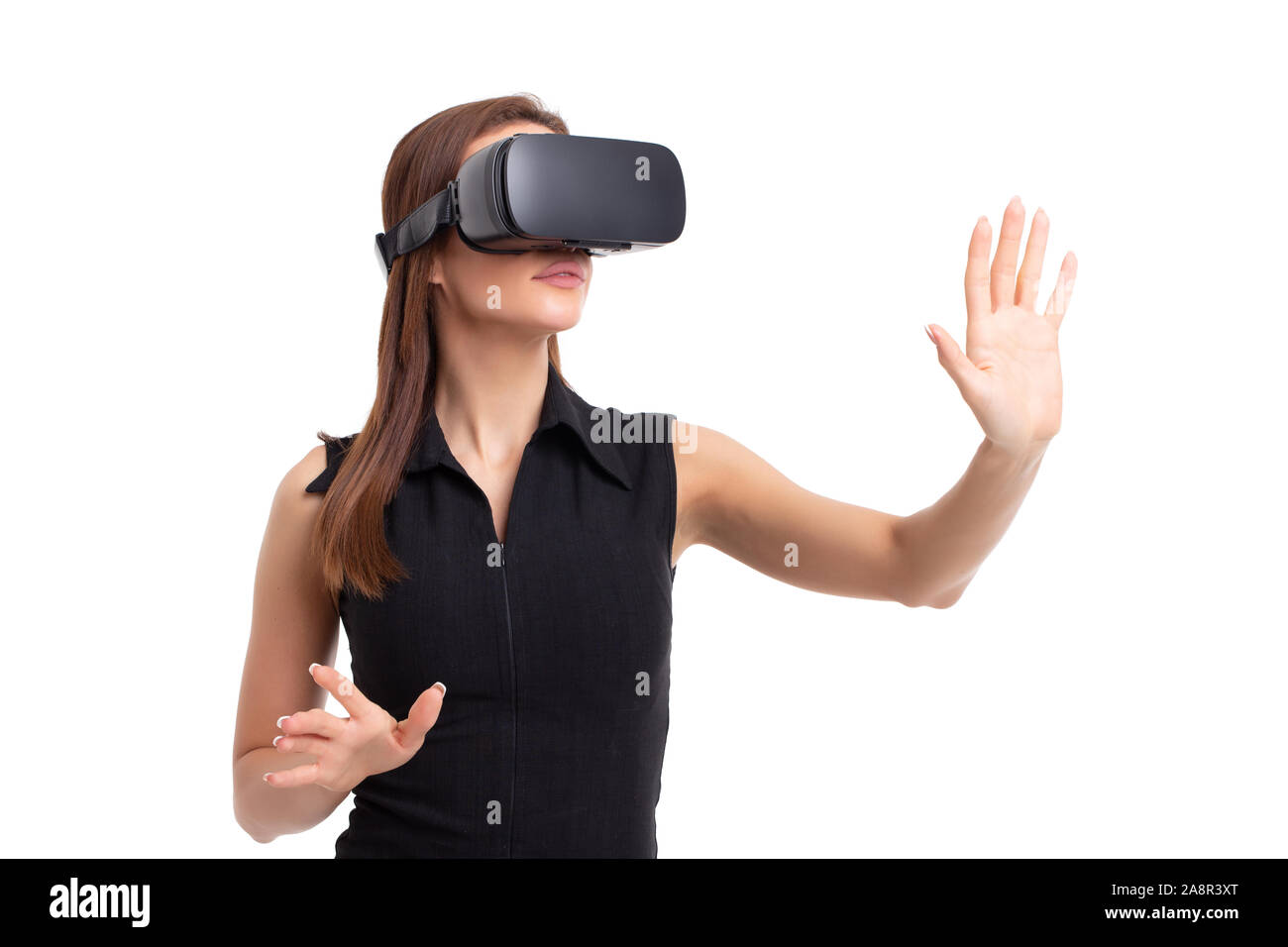 Young woman using VR headseat portrait, touching with hands, isolated on white Stock Photo