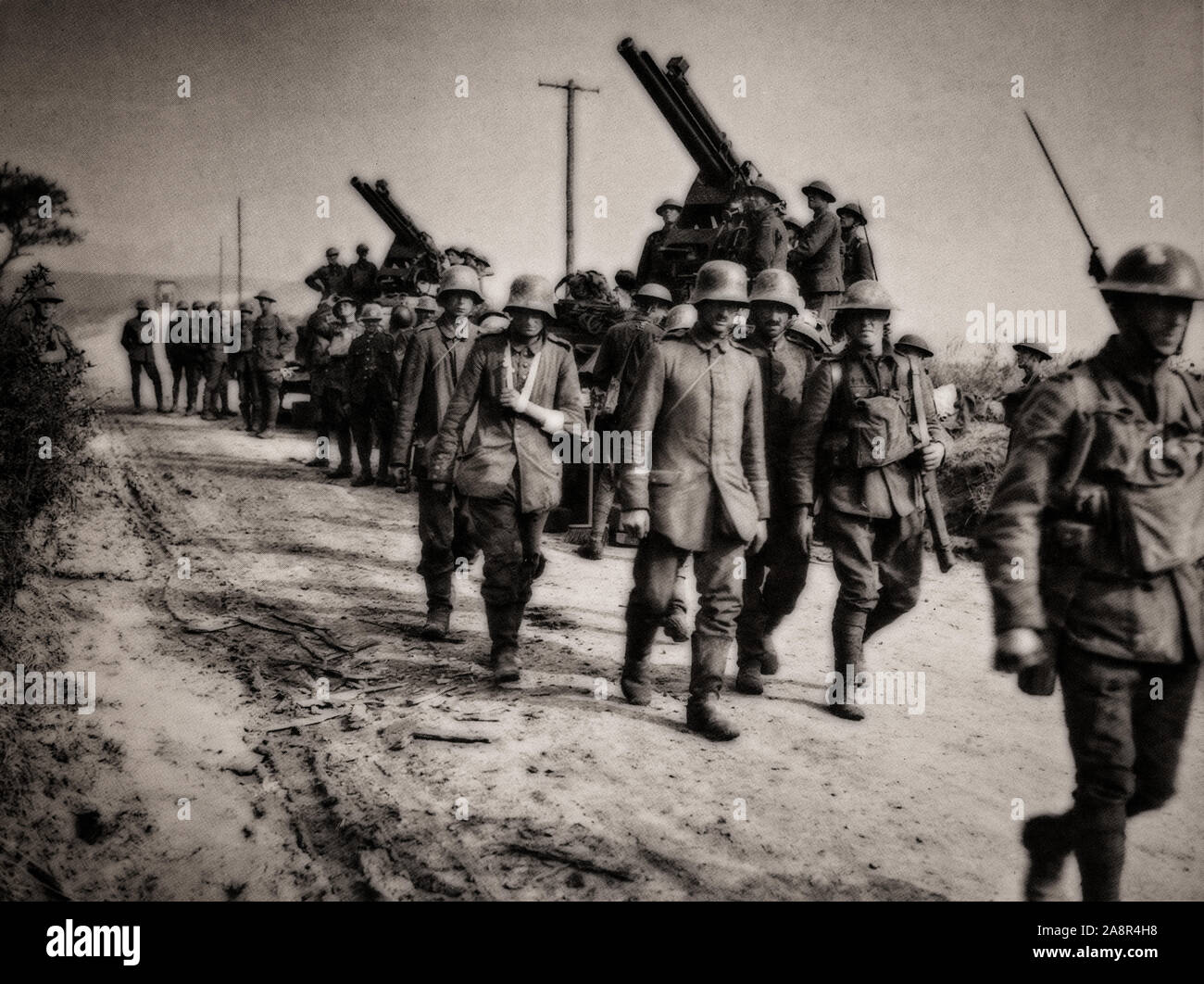 German prisoners of war escorted to the rear lines on the Black day of 8th August 1918. Earlier in March 1918, the Germans launched their Spring Offensive, consisting of four different major battles between March and July, that drove the Allies reeling back more than 50 miles. In the early morning hours of August 8, 1918, the German Army, depleted and exhausted by months of attacking, were taken completely by surprise when the British Fourth Army attacked and, by the end of the day, had punched a hole 15 miles wide in the front. Stock Photo