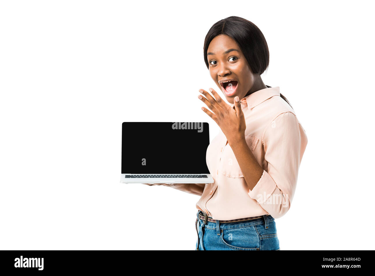 shocked african american woman in shirt holding laptop with copy space isolated on white Stock Photo