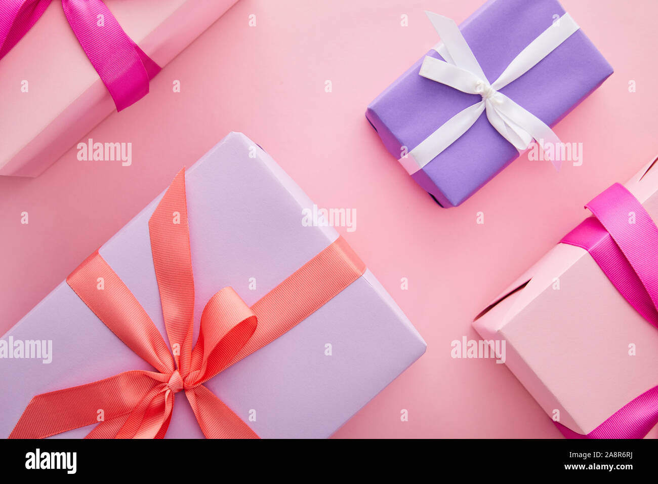 flat lay with colorful gift boxes with ribbons and bows scattered on