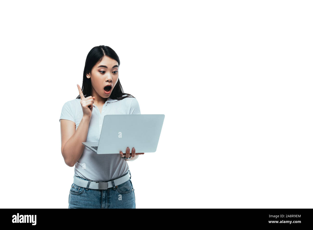 shocked asian girl with open mouth using laptop and showing idea gesture isolated on white Stock Photo