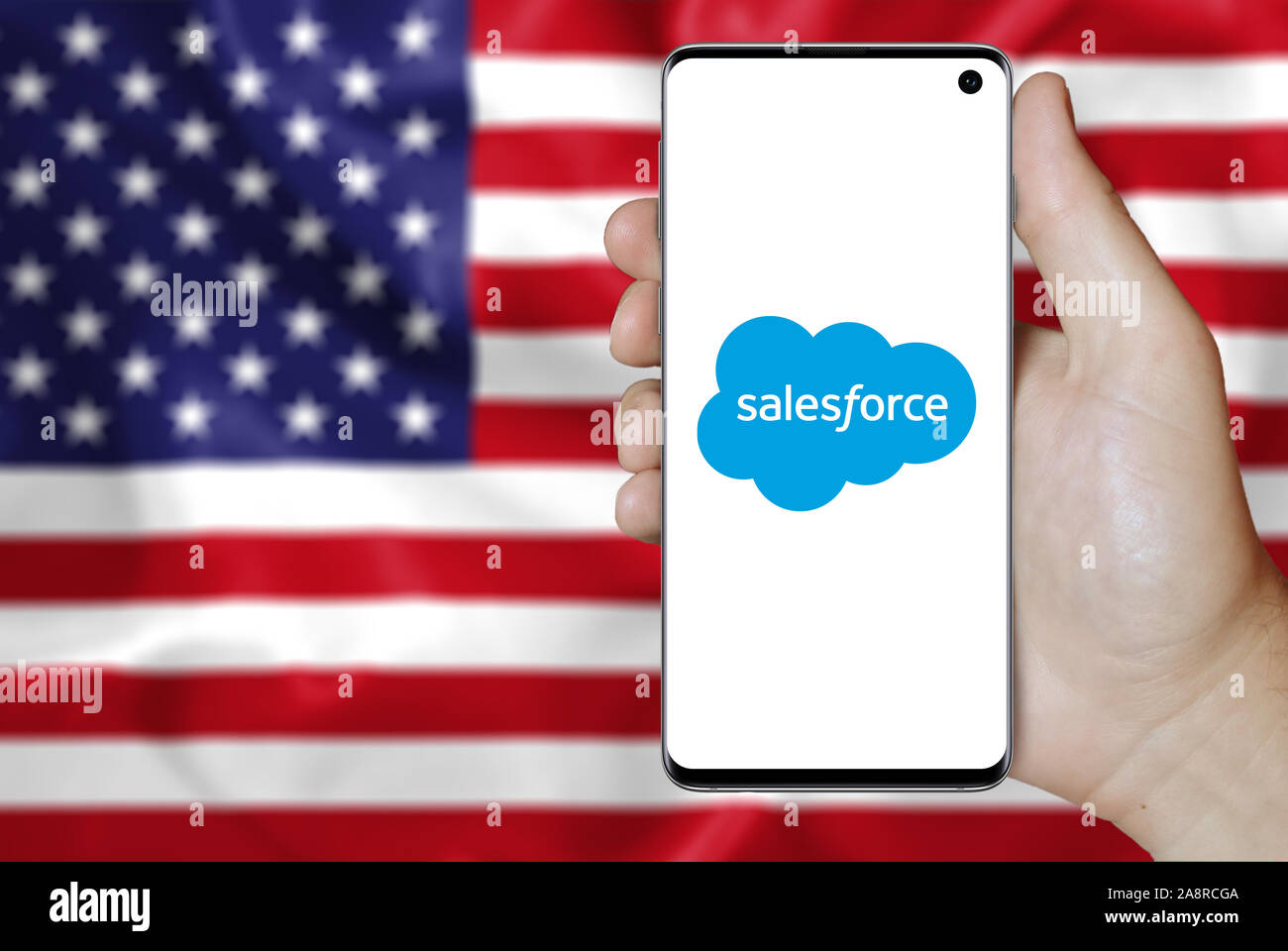 Logo of public company Salesforce displayed on a smartphone. Flag of USA  background. Credit: PIXDUCE Stock Photo - Alamy
