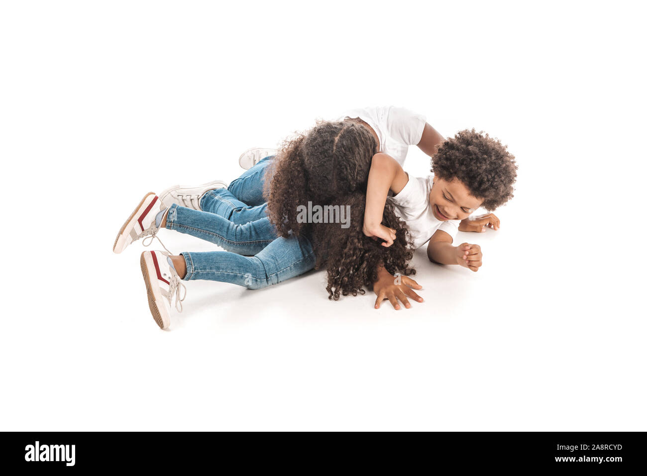 cheerful african brother and sister having fun while imitating fighting on white background Stock Photo