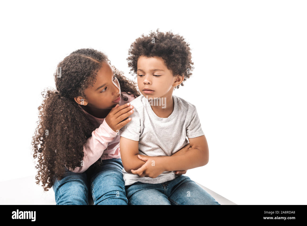 attentive african american sister calming down upset brother isolated on white Stock Photo
