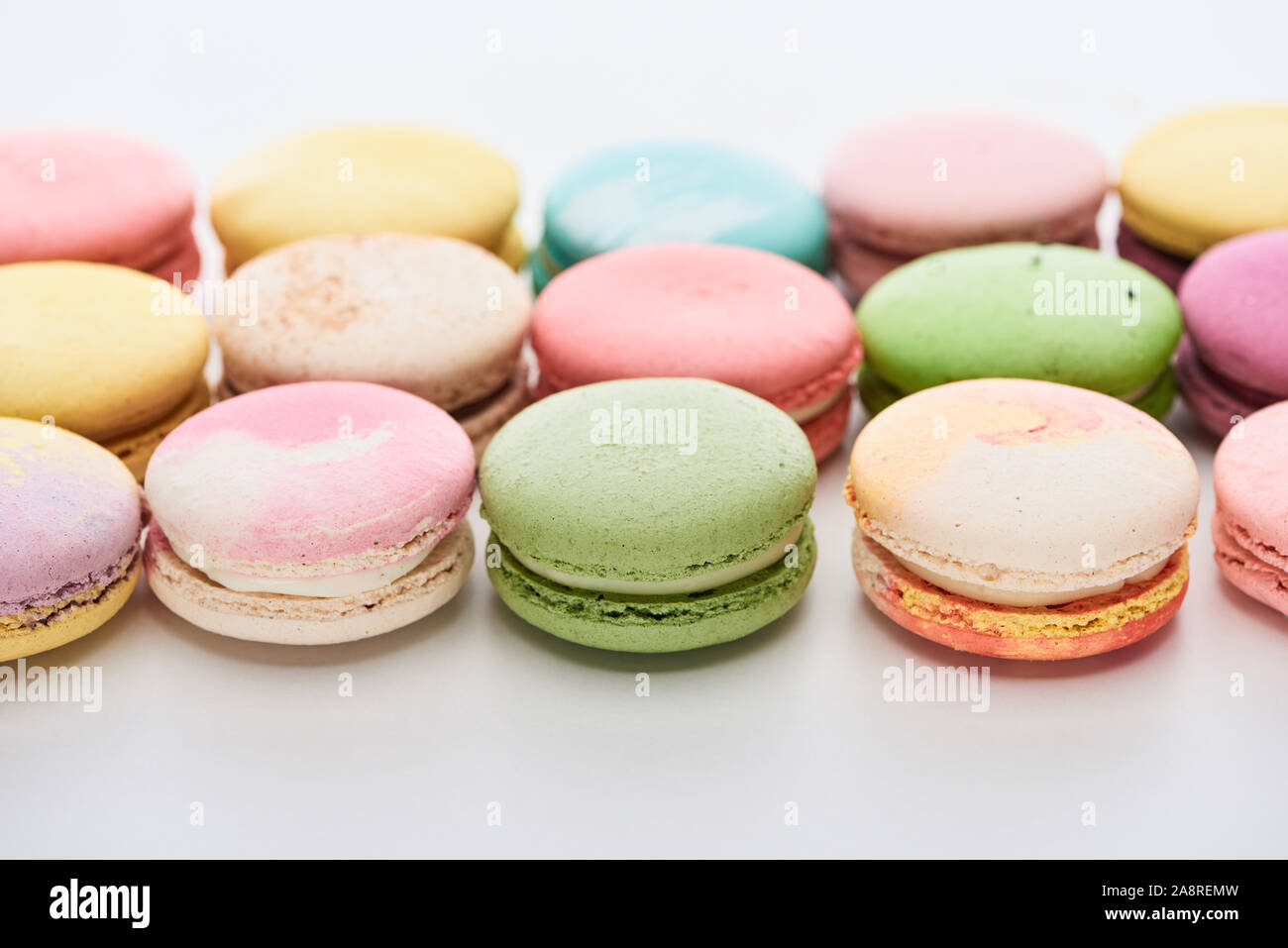 sweet colorful French macaroons of different flavors on white background Stock Photo