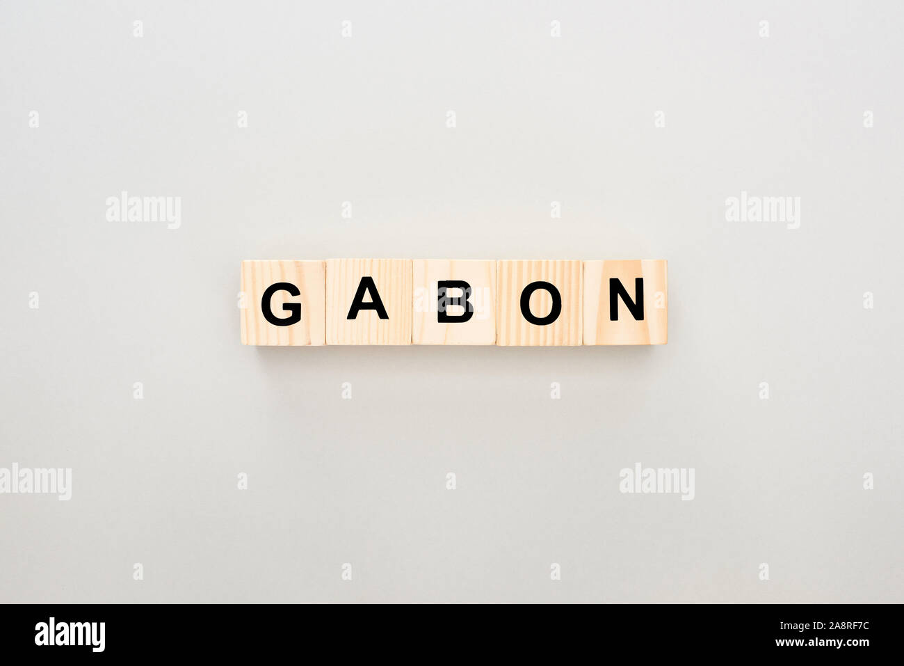 Gabon Fun Lettering top view of wooden blocks with Gabon lettering on white background ...