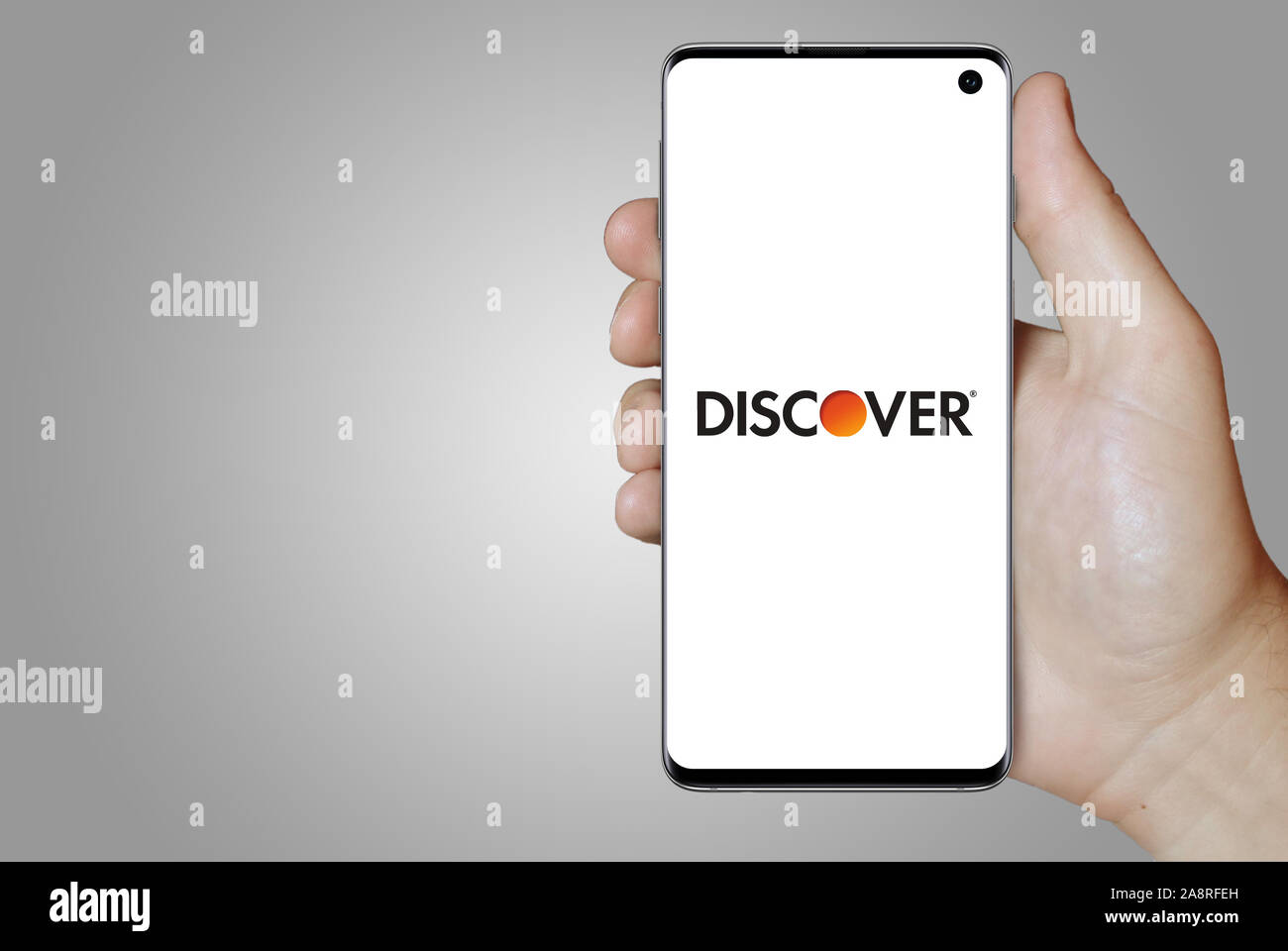 Logo of public company Discover Financial Services displayed on a smartphone. Grey background. Credit: PIXDUCE Stock Photo