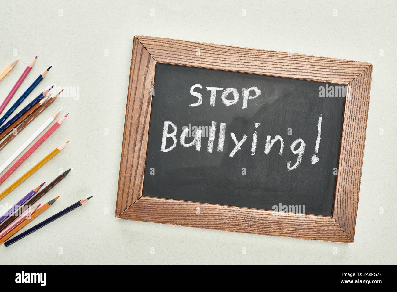 top view of chalkboard in wooden frame with stop bullying lettering ...