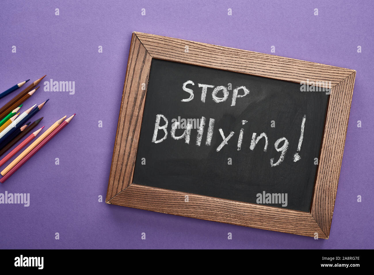 top view of chalkboard in wooden frame with stop bullying lettering ...