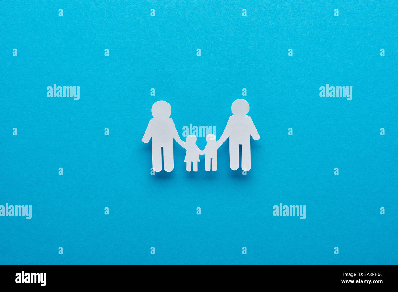 top view of paper cut family holding hands on blue background Stock ...