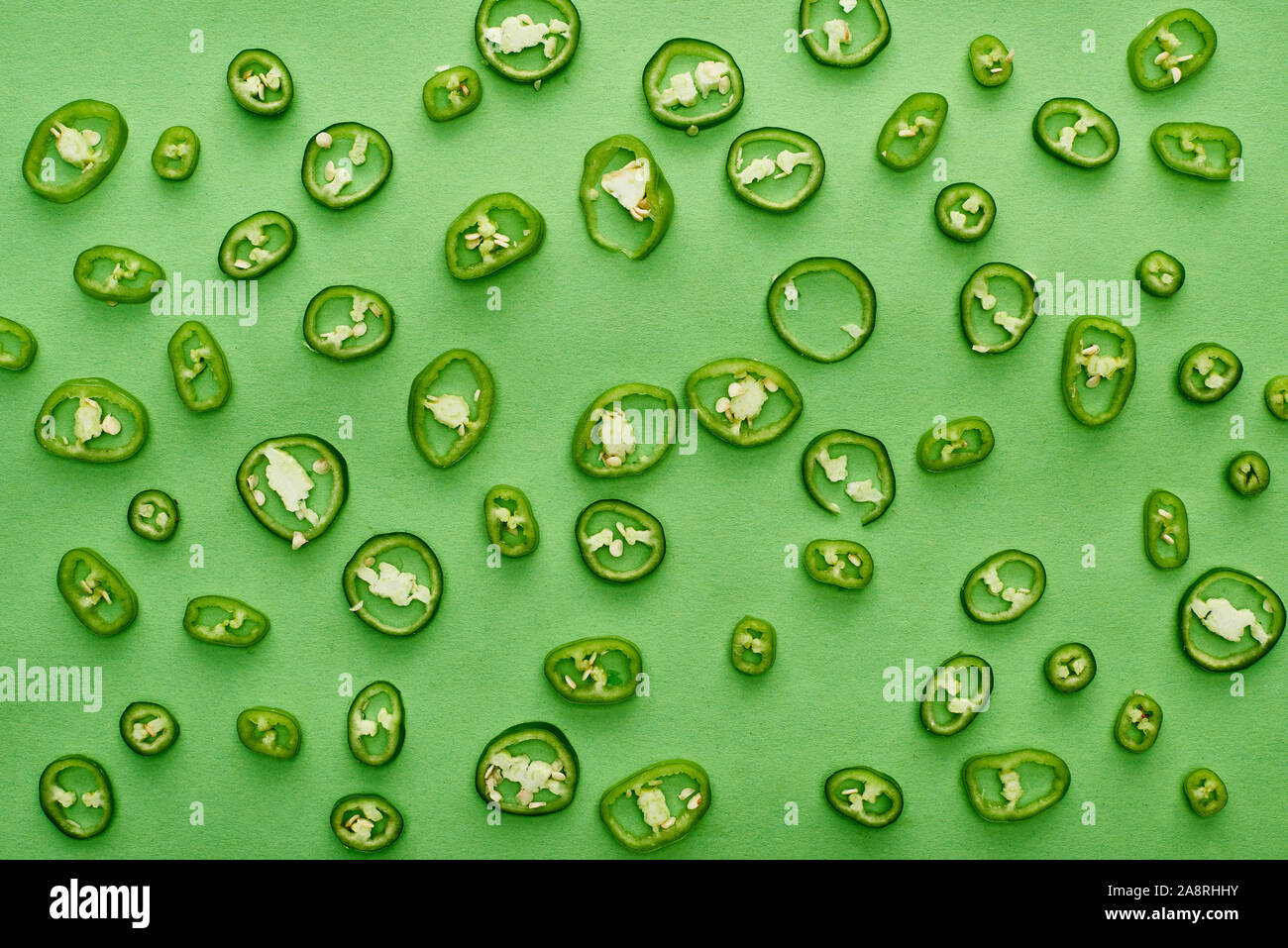 top view of sliced and fresh peppers on green background Stock Photo ...