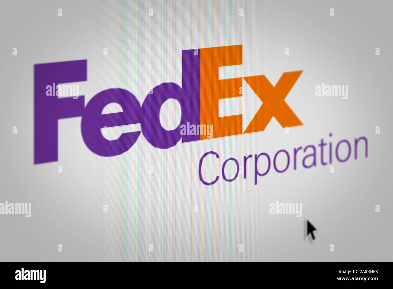 Logo of the public company FedEx Corporation displayed on a computer screen in close-up. Credit: PIXDUCE Stock Photo