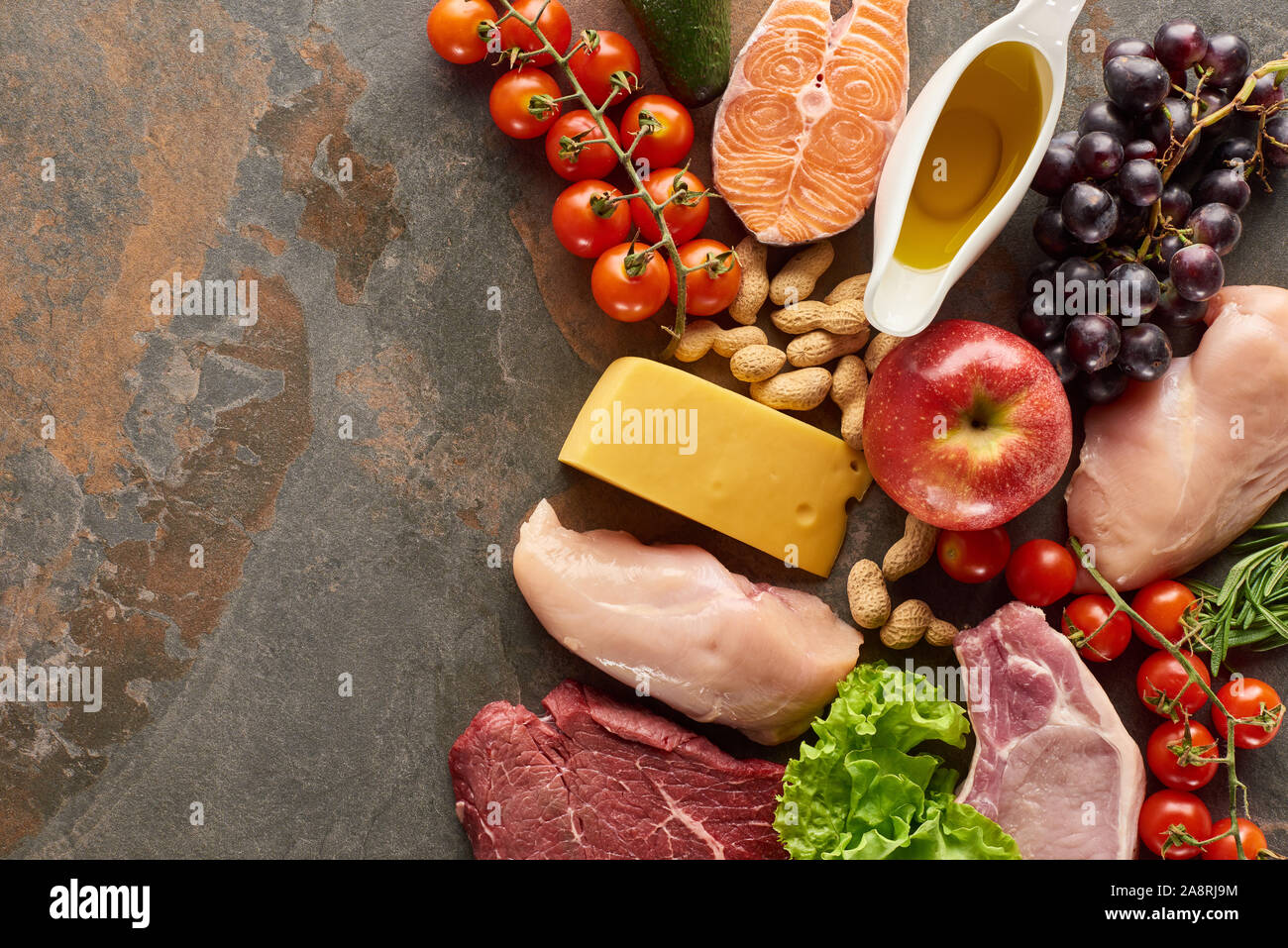 Top view of raw fish, meat and poultry near vegetables, fruits, cheese ...
