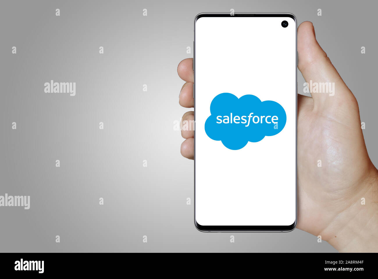Logo of public company Salesforce displayed on a smartphone. Grey background. Credit: PIXDUCE Stock Photo