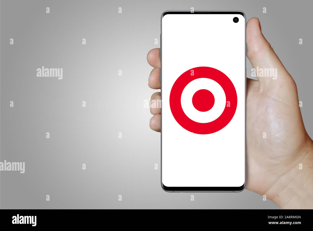 Logo of public company Target Corp. displayed on a smartphone. Grey background. Credit: PIXDUCE Stock Photo