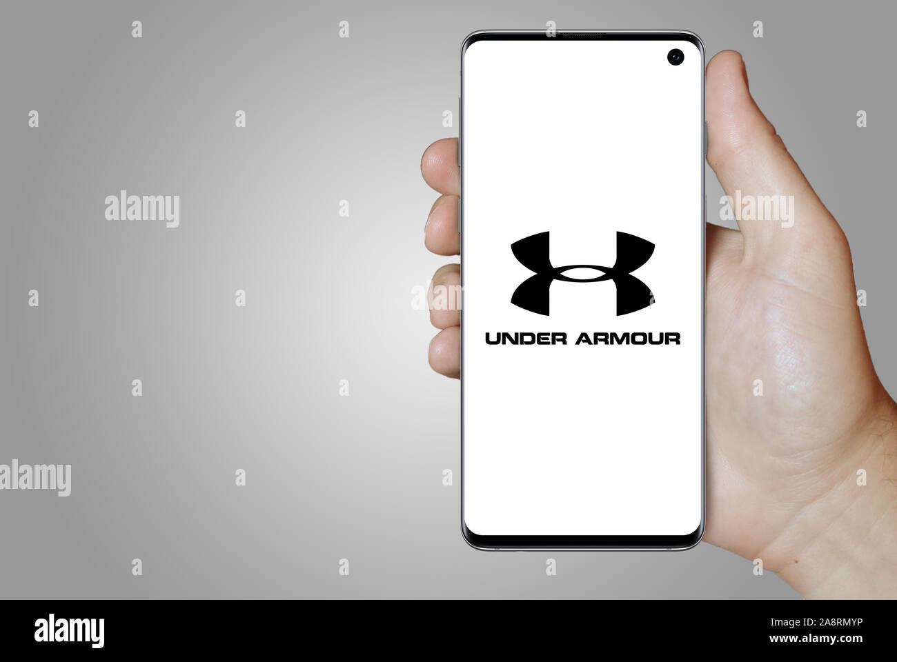 Logo of public company Under Armour displayed on a smartphone. Grey  background. Credit: PIXDUCE Stock Photo - Alamy