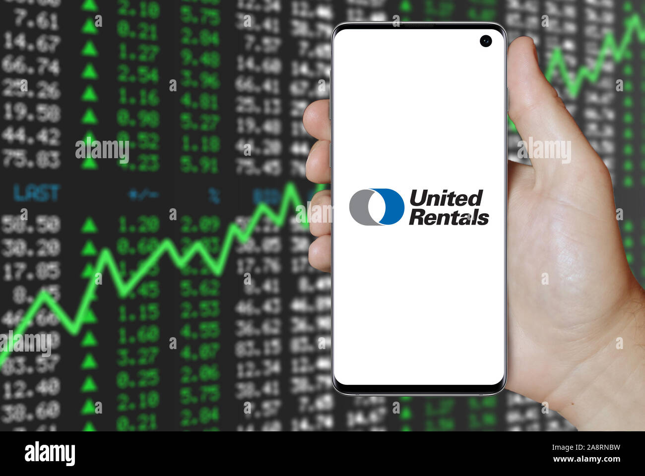 Logo of public company United Rentals, Inc. displayed on a smartphone. Positive stock market background. Credit: PIXDUCE Stock Photo