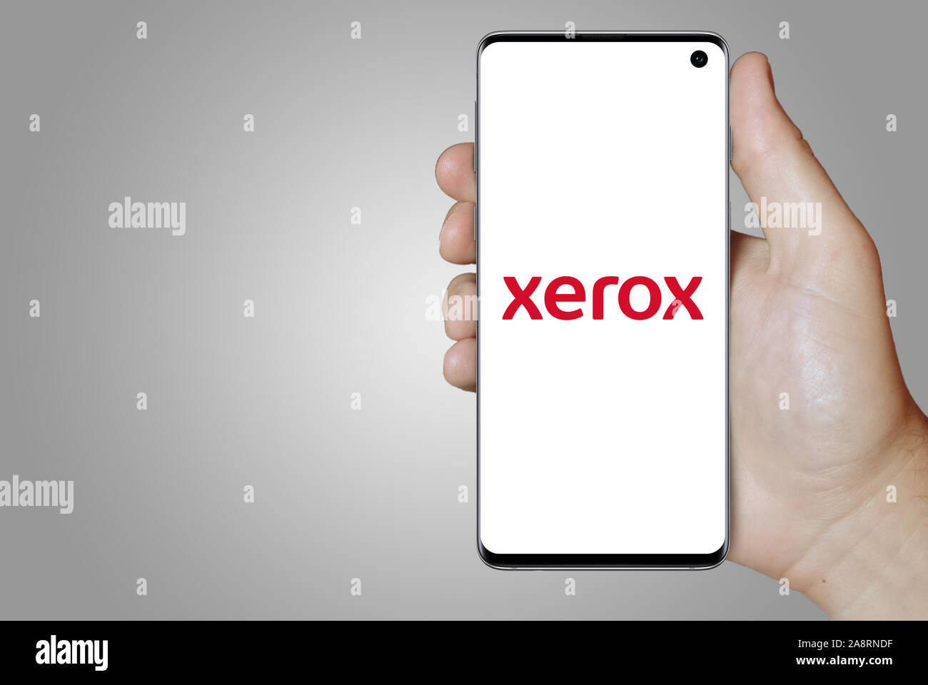 Logo of public company Xerox displayed on a smartphone. Grey background. Credit: PIXDUCE Stock Photo