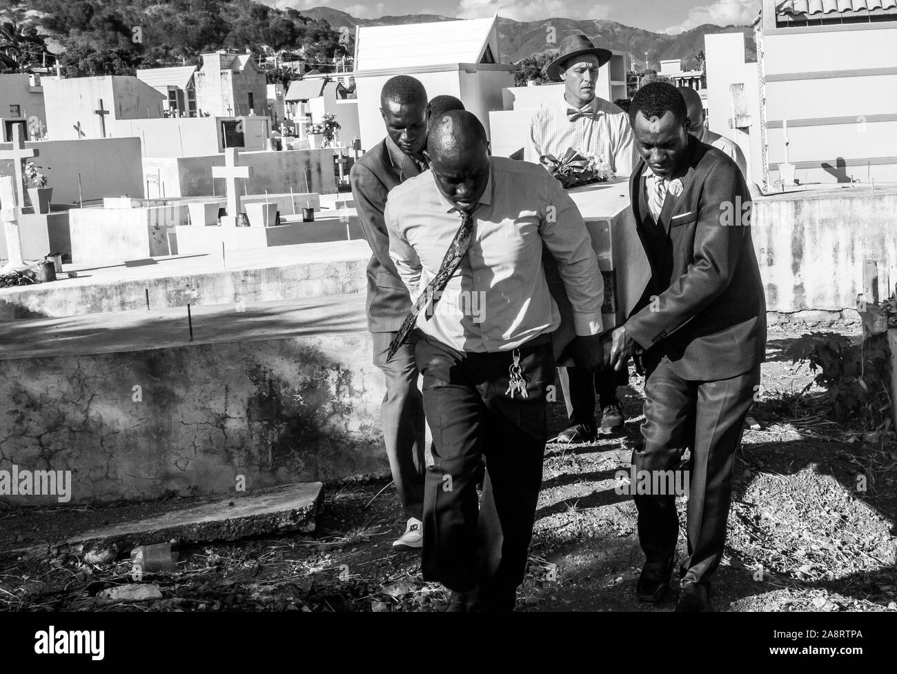 dramatic image of Haitian men carrying casket of loved one to the grave Stock Photo