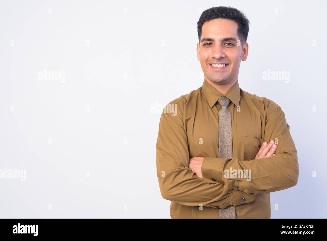 Portrait of happy handsome Persian businessman smiling with arms ...