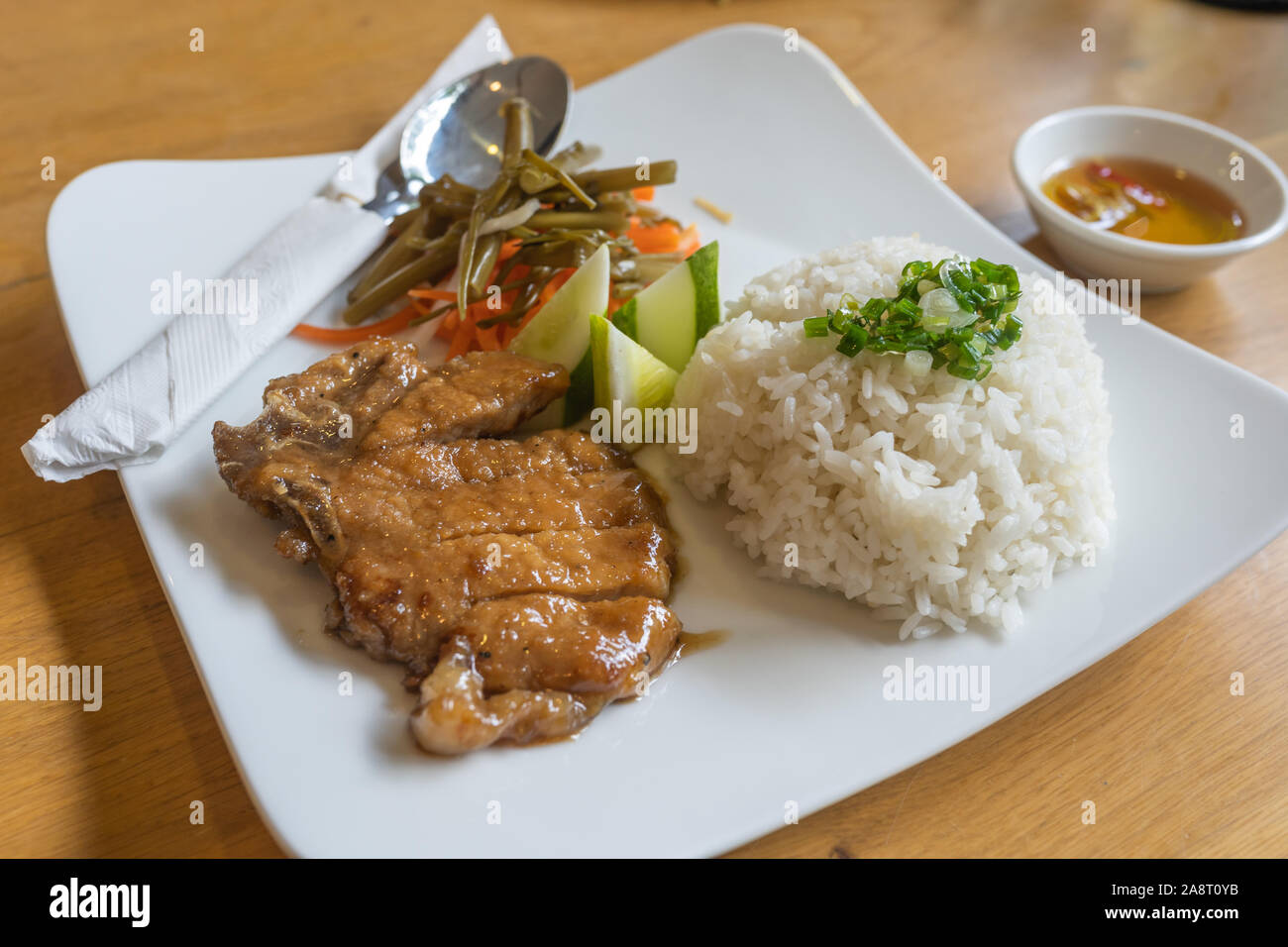Vietnam gastronomy pork chop broken rice served with pickles Stock